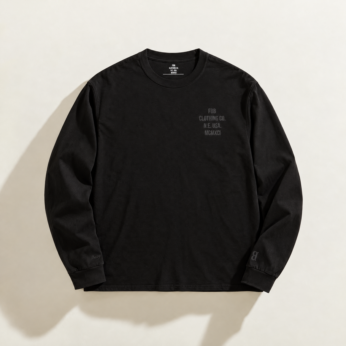 Front of the black FBB Blacked Out long-sleeve tee with tonal FBB Clothing Co. embroidery on the left chest.

