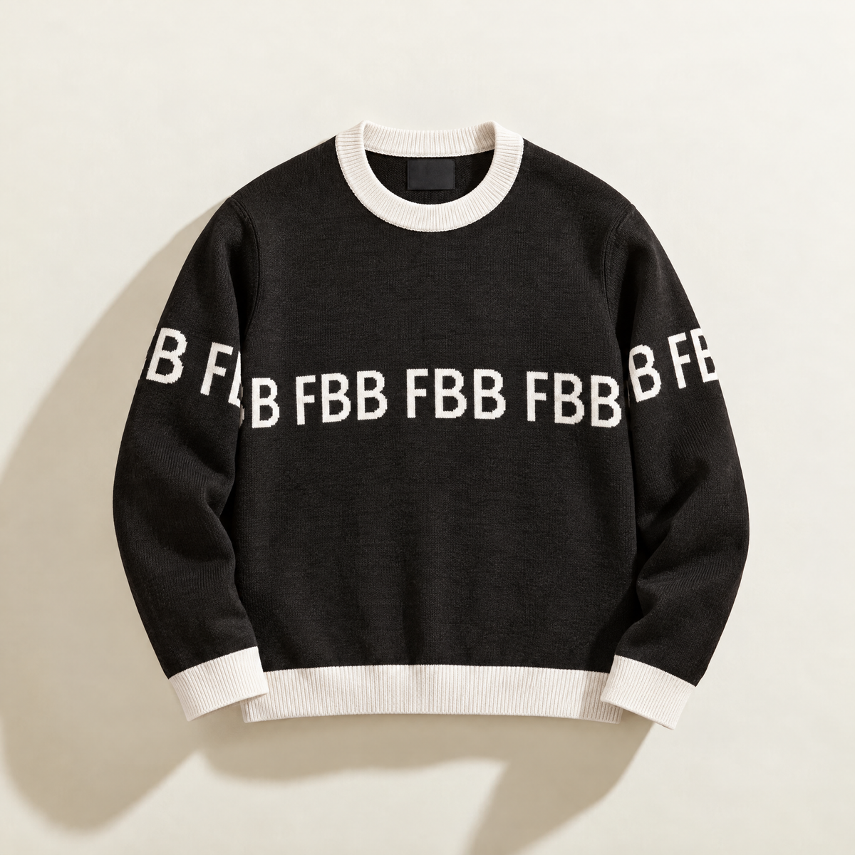 FBB Legacy Black knit sweater with white ribbed trim and repeating white FBB lettering across the chest and sleeves.
