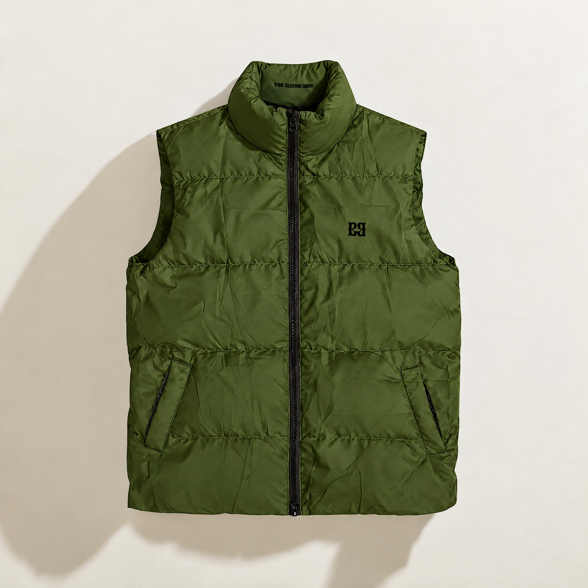 front: FBB Barrier Army Drab down puffer vest with a stand collar, zip front, angled pockets and printed chest logo.
