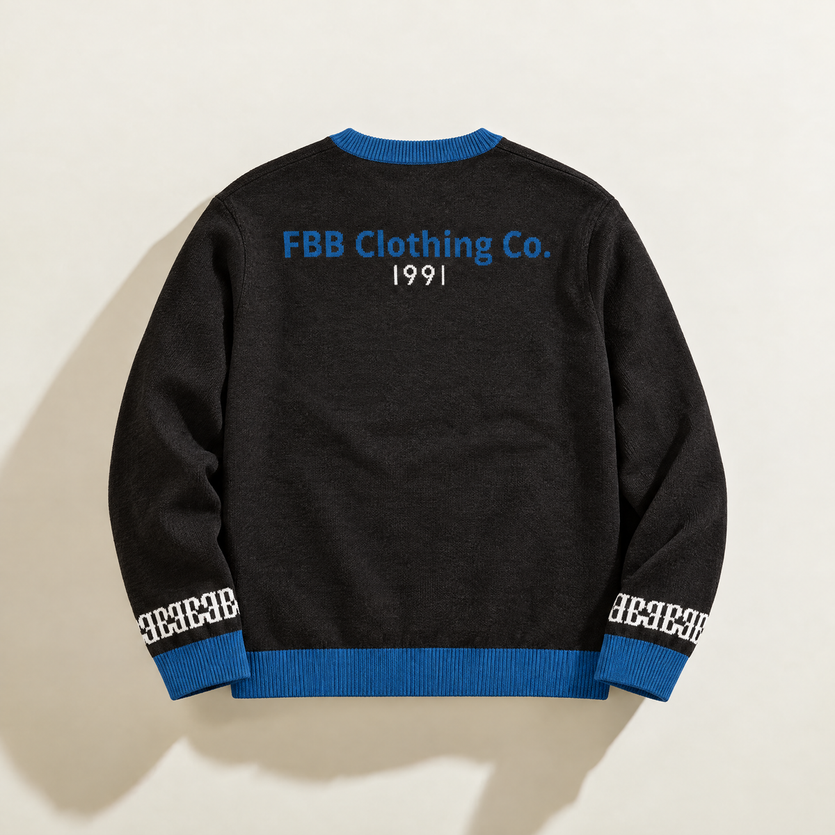 Back of FBB Black & Blue knit sweater with blue trim, blue FBB Clothing Co. lettering and white 1991 detail.
