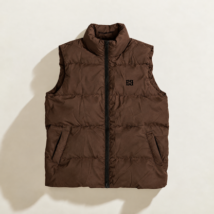 A sleeveless quilted down puffer vest in brown, featuring a black front zipper, a stand-up collar, and a small black logo on the left chest, displayed against a solid white background.