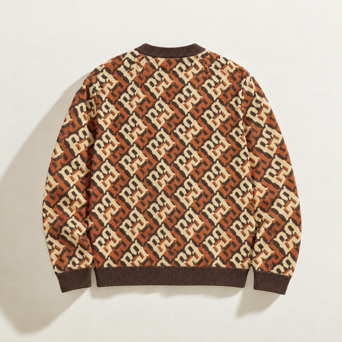Back of FBB Coco Cream Breaker knit sweater showing the all-over cream and brown monogram pattern.

