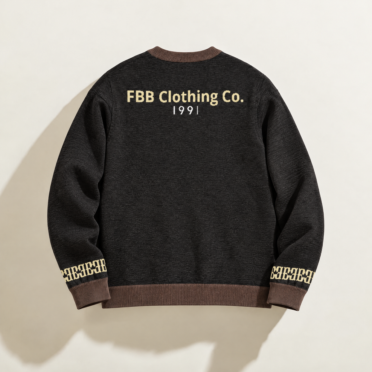 Back of FBB Coco Cream knit sweater with brown trim, blue FBB Clothing Co. lettering and white 1991 detail.

