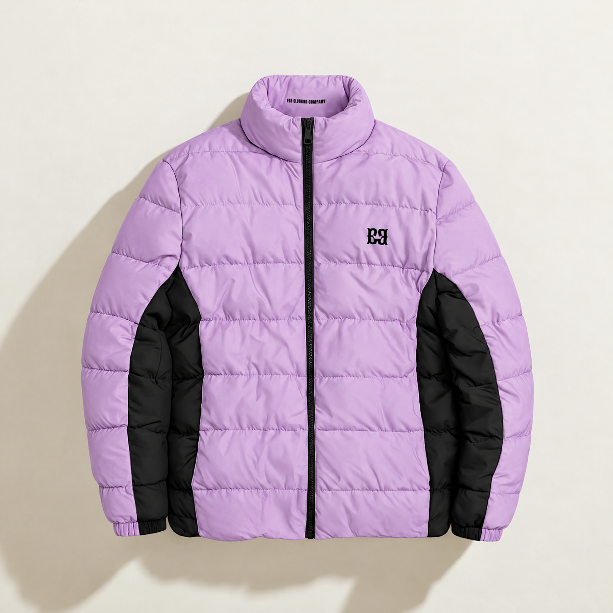 Front view of the purple FBB puffer jacket with black side panels, a black zipper and chest monogram.