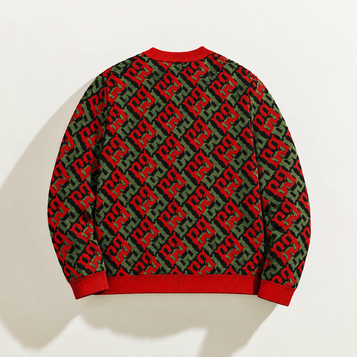 Back of FBB RGB Breaker knit sweater with red and green monograms on black and red ribbed collar, cuffs and hem.
