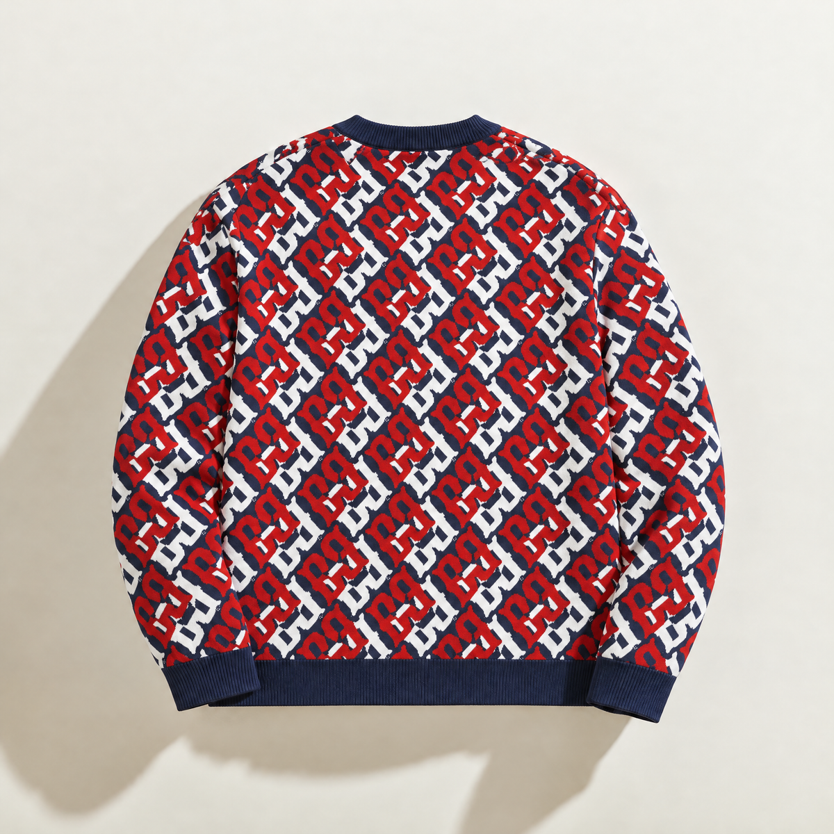 Back of FBB RWB Breaker knit sweater showing the repeating red, white and dark blue monogram pattern.

