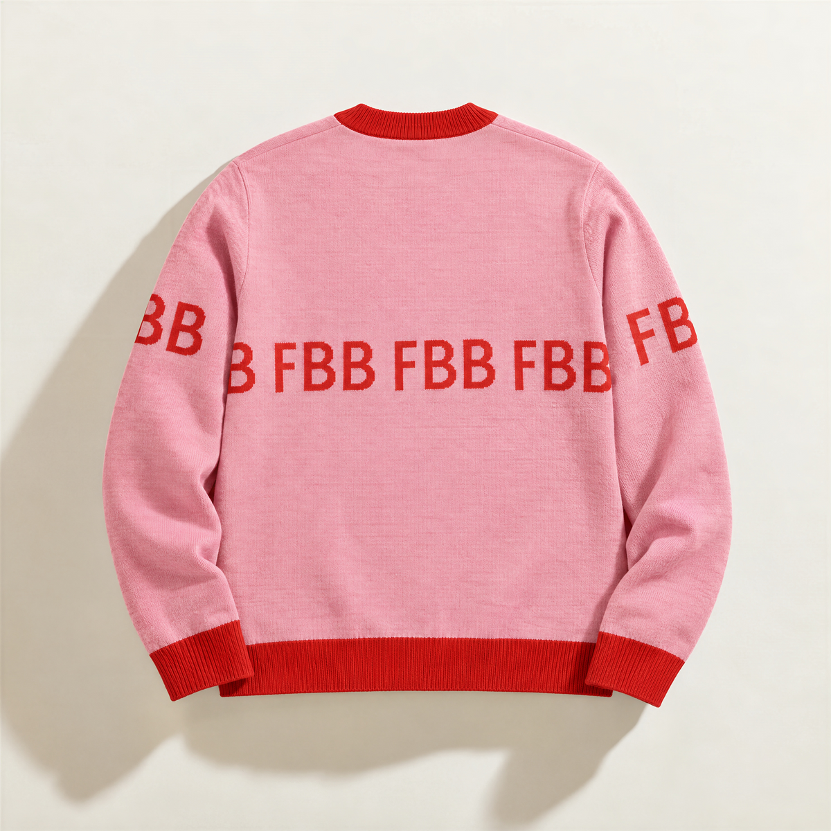 FBB Legacy Strawberry Hearts pink signature knit sweater, back view with red FBB lettering across the back and sleeves.