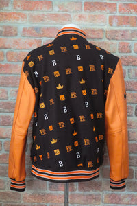 Varsity jacket with brown, orange, and white design on a gray surface | FBB M3 VARSITY One‑of‑One Collector’s Edition